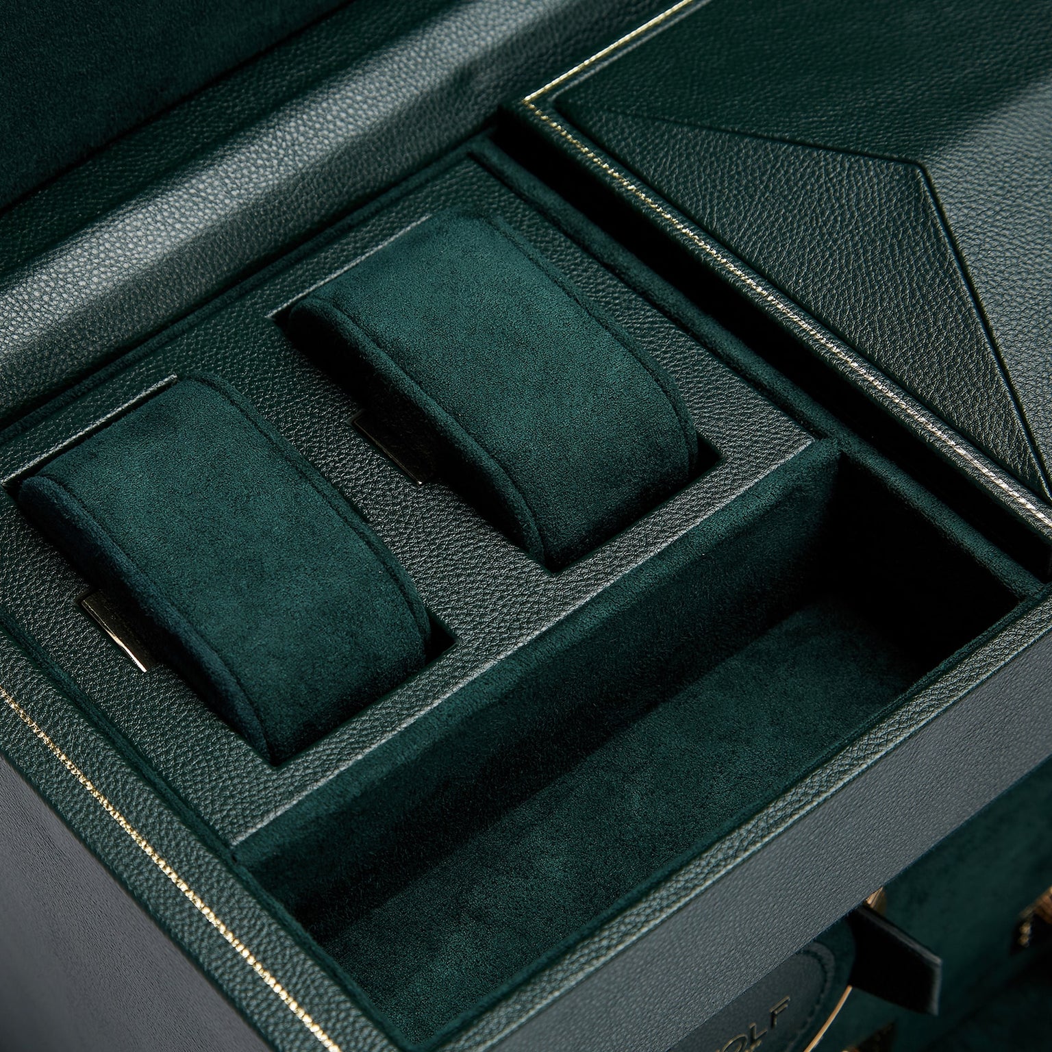 The WOLF British Racing Double Watch Winder with Storage features a dark green leather and suede interior, complete with empty watch cushions and compartments.