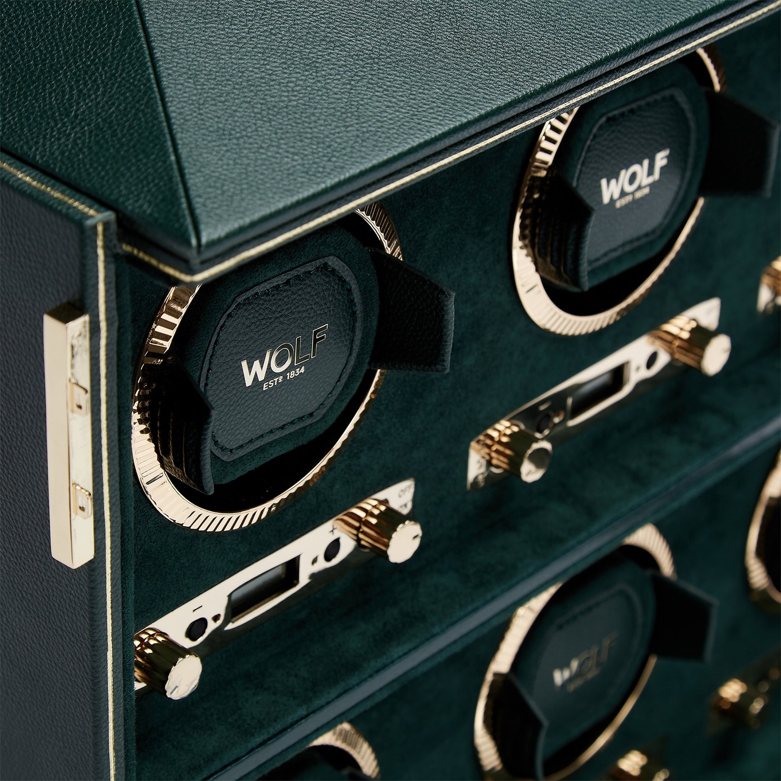 Close-up of the WOLF British Racing 6 Piece Watch Winder, featuring green and gold accents, multiple winding slots, and luxurious detailing.