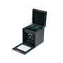 The WOLF British Racing Single Watch Winder with Storage is shown in dark green with the lid open, displaying a watch and cushioned holders inside.