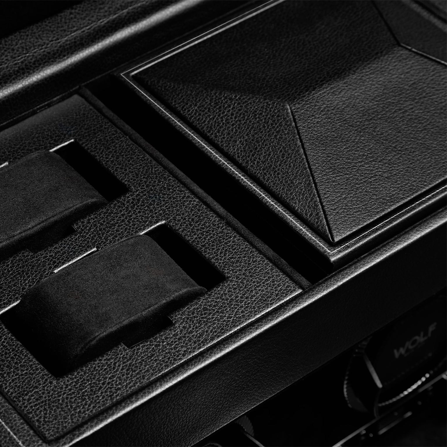Close-up of the WOLF British Racing Triple Watch Winder with Storage, featuring a black leather finish, textured lid, and cushioned slots.