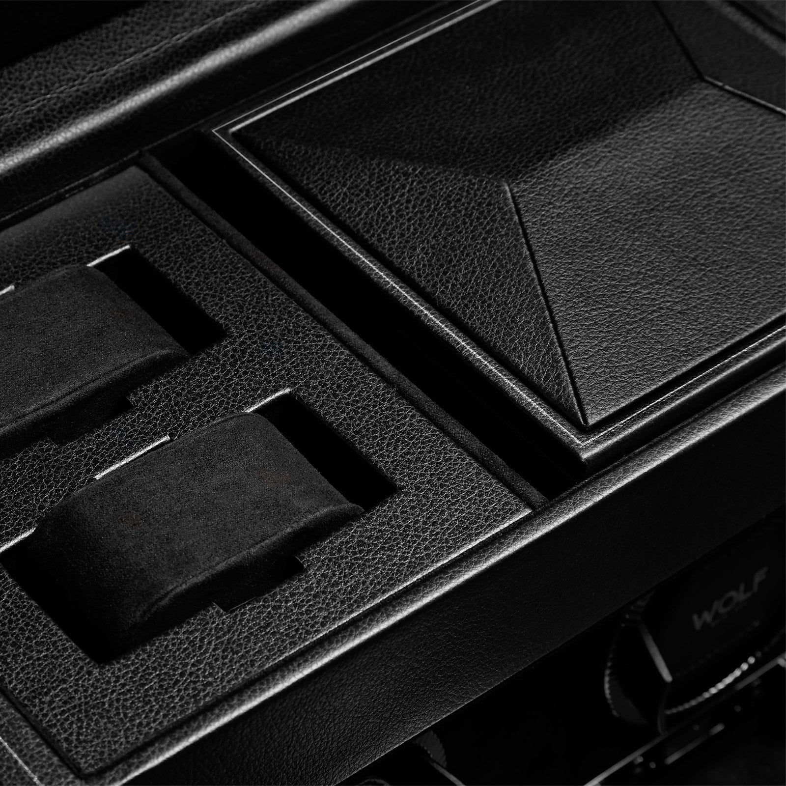 Close-up of the WOLF British Racing Triple Watch Winder with Storage, featuring a black leather finish, textured lid, and cushioned slots.