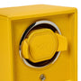 The WOLF Cub Single Watch Winder with Cover features a yellow finish, a round metal frame, and a coordinating yellow watch holder inside.