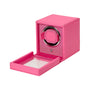The WOLF Cub Single Watch Winder with Cover features a bright pink design, an open transparent front door, and a circular holder inside.