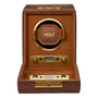 Brown leather watch winder with gold-tone hardware, circular brown leather watch cushion, digital display, and control button