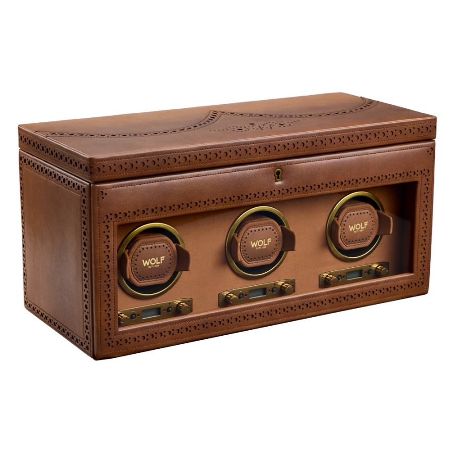 Brown leather watch winder with three rotating mechanisms and perforated detailing, featuring brass accents and storage compa