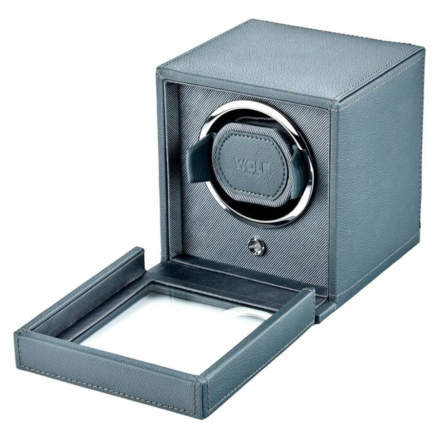 Gray leather watch winder with single rotating watch holder and open cover, showing interior mechanism.