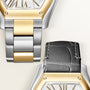Two-tone watch with gold and silver metal bracelet and black leather strap, hexagonal dial with Roman numerals marked "Swiss 