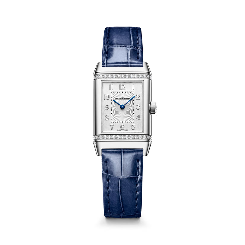 Silver rectangular watch with diamond-set bezel, silver dial with Arabic numerals, blue hands, and blue crocodile leather str