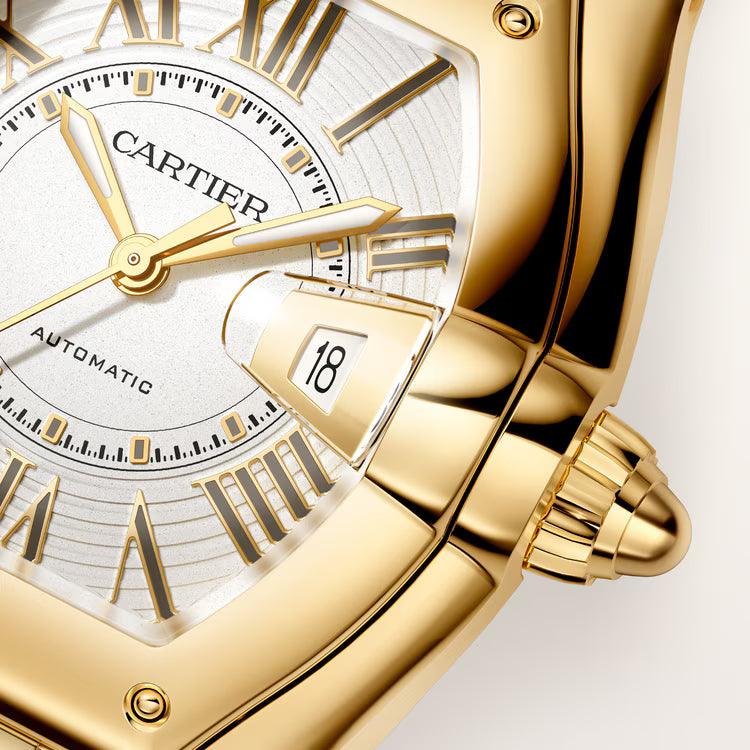 Gold-tone Cartier Roadster watch with white dial, Roman numerals, date window, and gold bracelet strap.