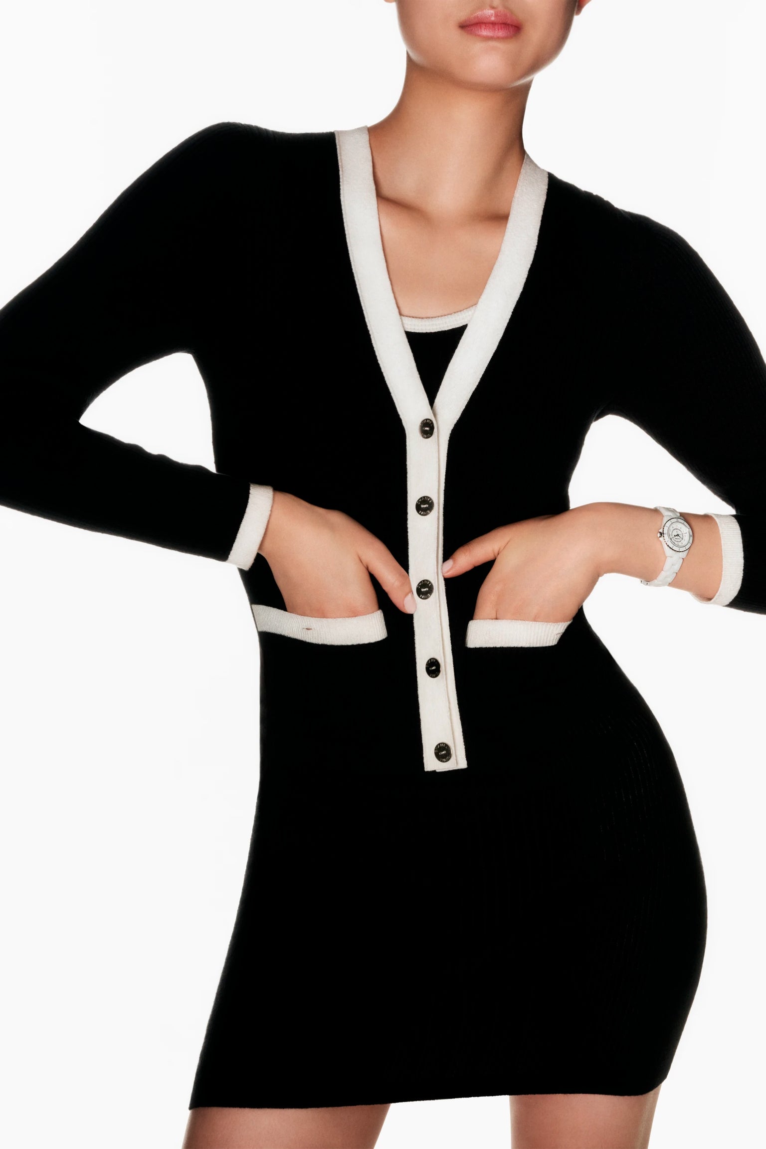 Black dress with white trim worn by a model on a white background