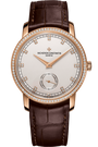 Rose gold watch with white dial, diamond bezel, small seconds subdial, and brown leather strap.