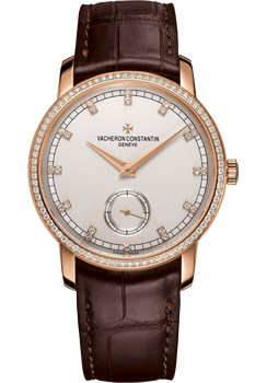 Rose gold watch with white dial, diamond bezel, small seconds subdial, and brown leather strap.