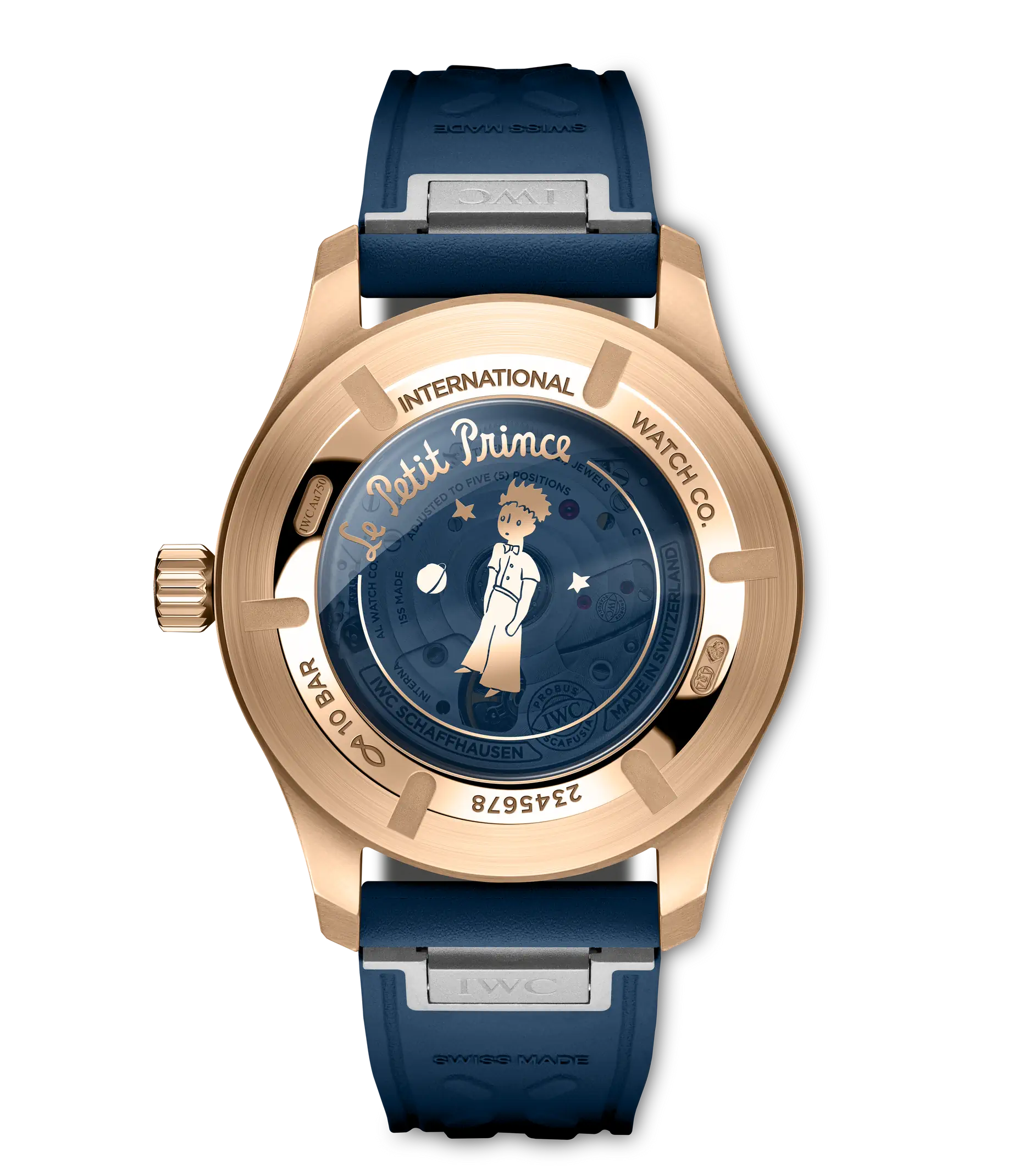 Rose gold pilot's watch with dark blue dial featuring Le Petit Prince illustration, blue rubber strap, and visible case back.
