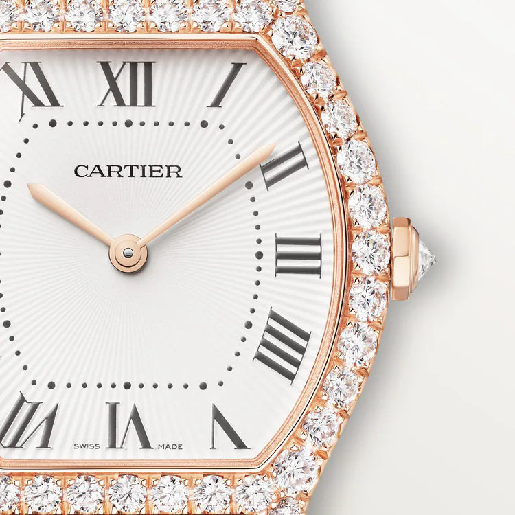 Rose gold Cartier Tortue watch with white dial, Roman numerals, and diamond-set bezel.