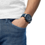 Person wearing a blue watch on a white background