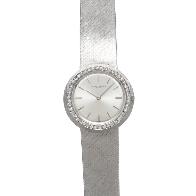 The Vacheron Constantin White Gold Diamond Bezel is a minimalist wristwatch featuring a diamond-bordered round face and a textured metal band.