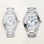 Two silver-tone stainless steel watches with barrel-shaped cases, blue Roman numeral dials, and matching metal bracelets disp