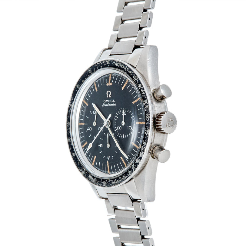 A Speedmaster Ed White by Watches of Switzerland, featuring a silver case, black dial, and stainless steel bracelet, viewed from an angle.