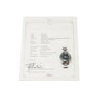An OMEGA Speedmaster watch rests atop its official extract of archives document.