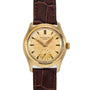 A Patek Philippe Calatrava vintage gold wristwatch featuring a round cream dial and brown leather strap.