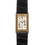 A Cartier Tank Basculante Mécanique 150th Anniversary Limited Edition wristwatch featuring a rectangular gold case, white dial with Roman numerals, and a black leather strap.