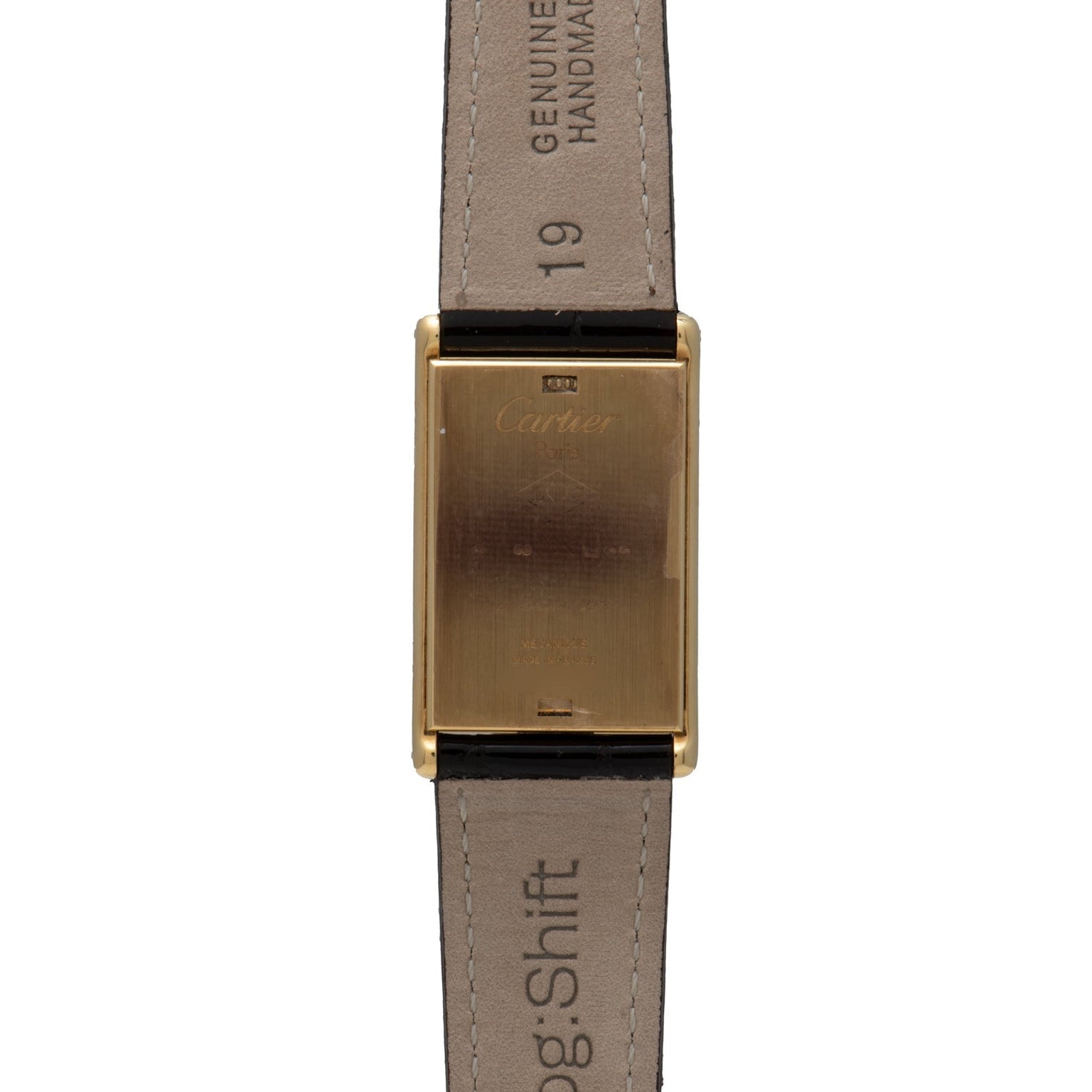 A Cartier Tank Basculante Mécanique 150th Anniversary Limited Edition gold rectangular watch case with leather straps, shown from the back.