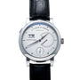 The Lange & Sohne Lange 31 is a luxury wristwatch with a black leather strap, silver dial, and date display.