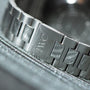 Close-up of the IWC Schaffhausen Aquatimer GST 2000s silver metal bracelet, featuring the engraved IWC logo on its clasp.