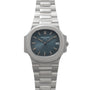 The Patek Philippe Nautilus features a blue dial with date display and is presented on a silver metal bracelet.