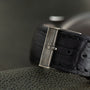 Close-up of a black leather Portugieser watch strap by IWC Schaffhausen, featuring a silver clasp engraved with the brand’s name.