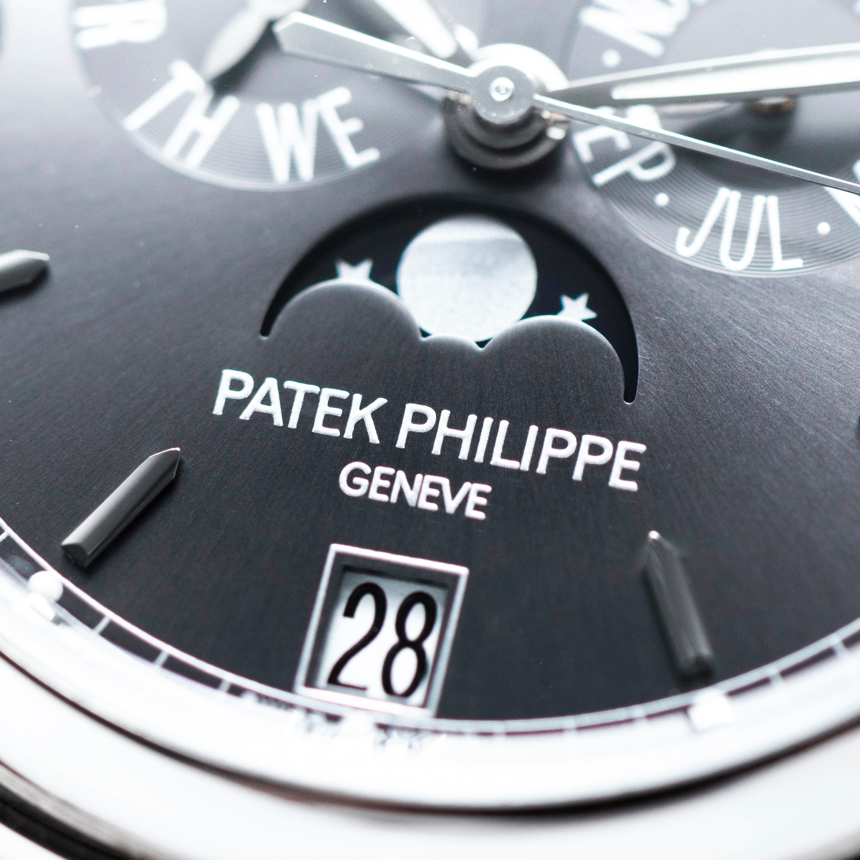 Close-up of the Patek Philippe Annual Calendar Moonphase watch face, featuring the moonphase indicator, brand logo, and date display.