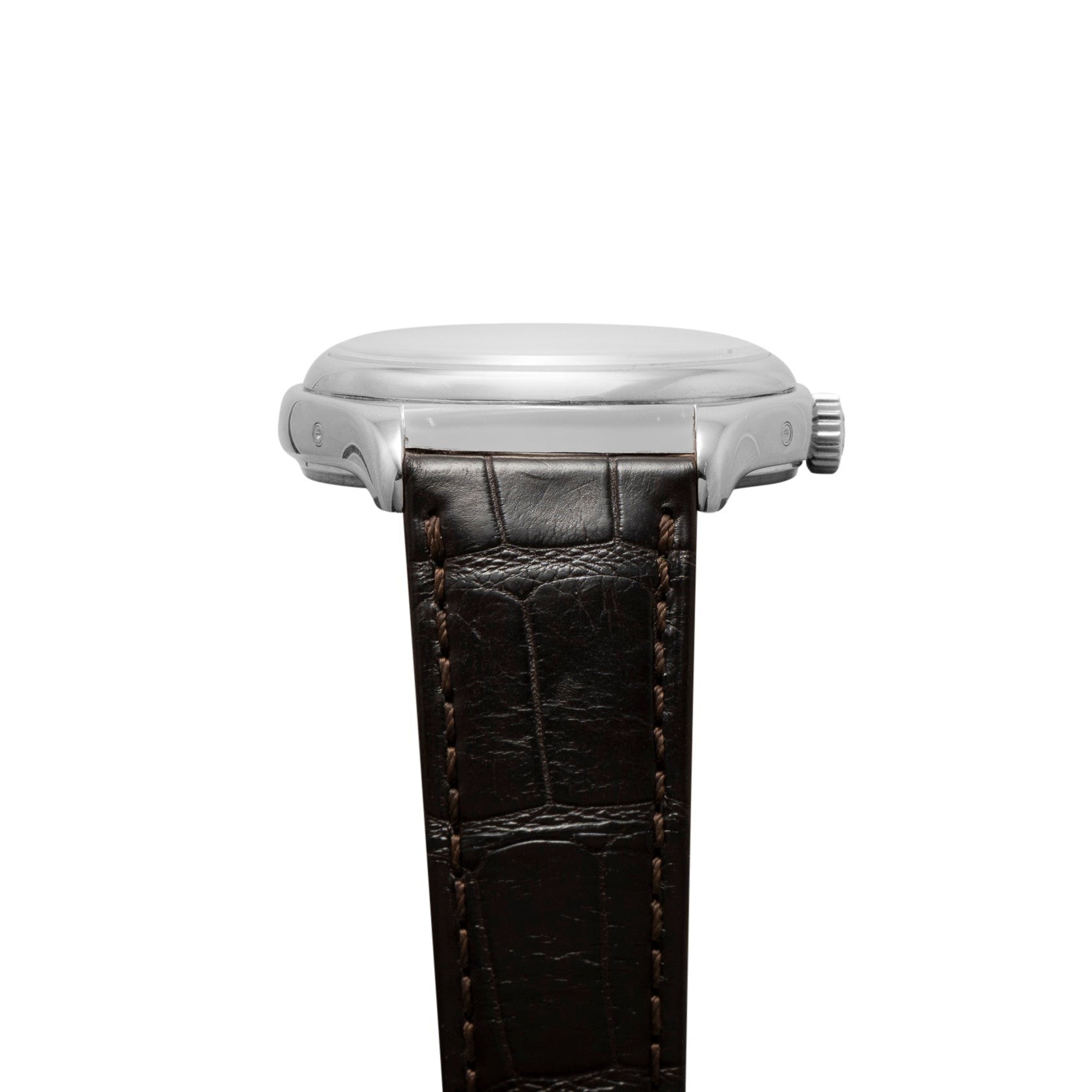 Side view of the Patek Philippe Annual Calendar Moonphase wristwatch in silver with a brown leather strap and visible stitching.