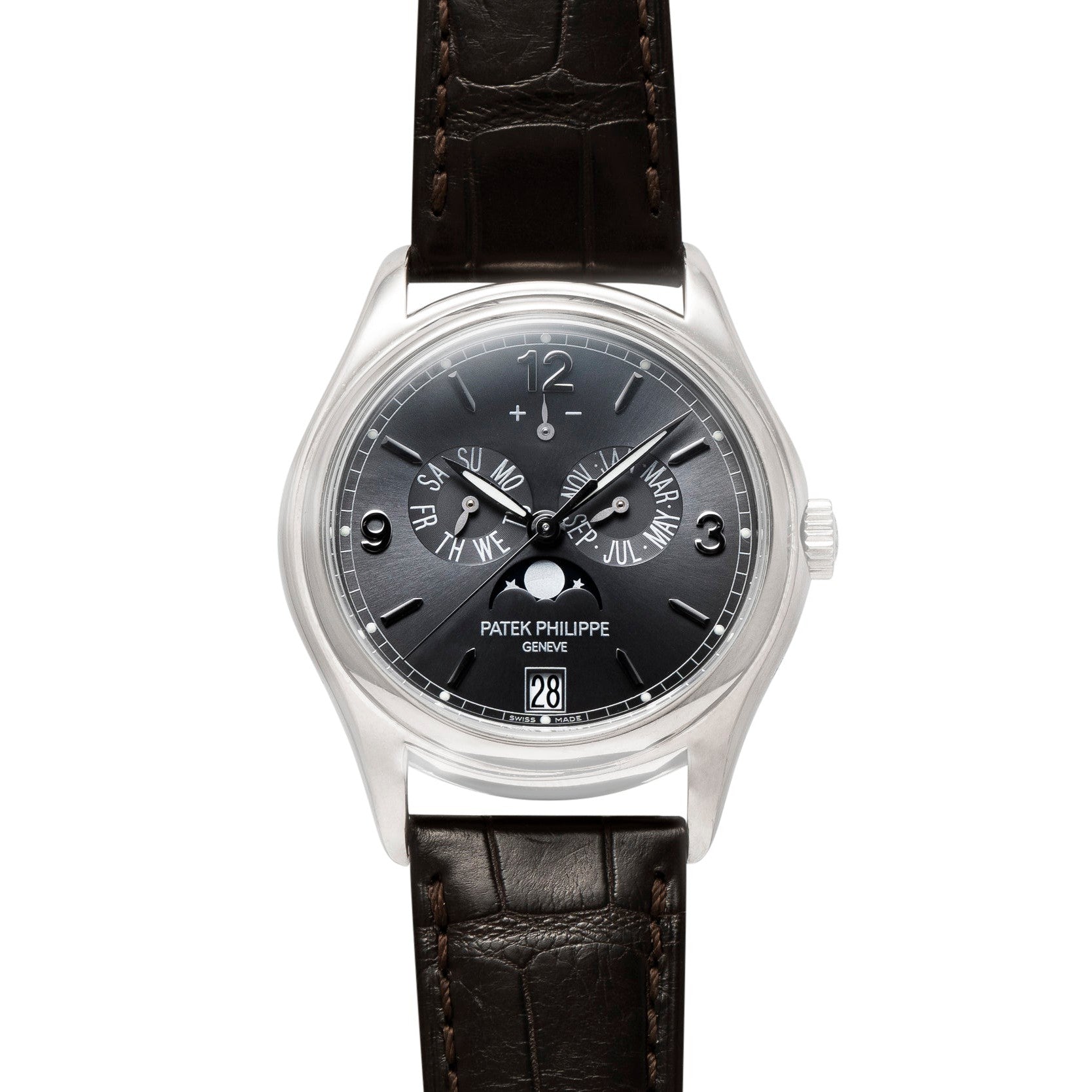 A Patek Philippe Annual Calendar Moonphase wristwatch featuring a black dial, silver case, and brown leather strap.