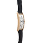 Cartier Tank Cintrée Jumbo: Gold rectangular wristwatch with curved face, black Roman numerals, and a black leather strap, side view.