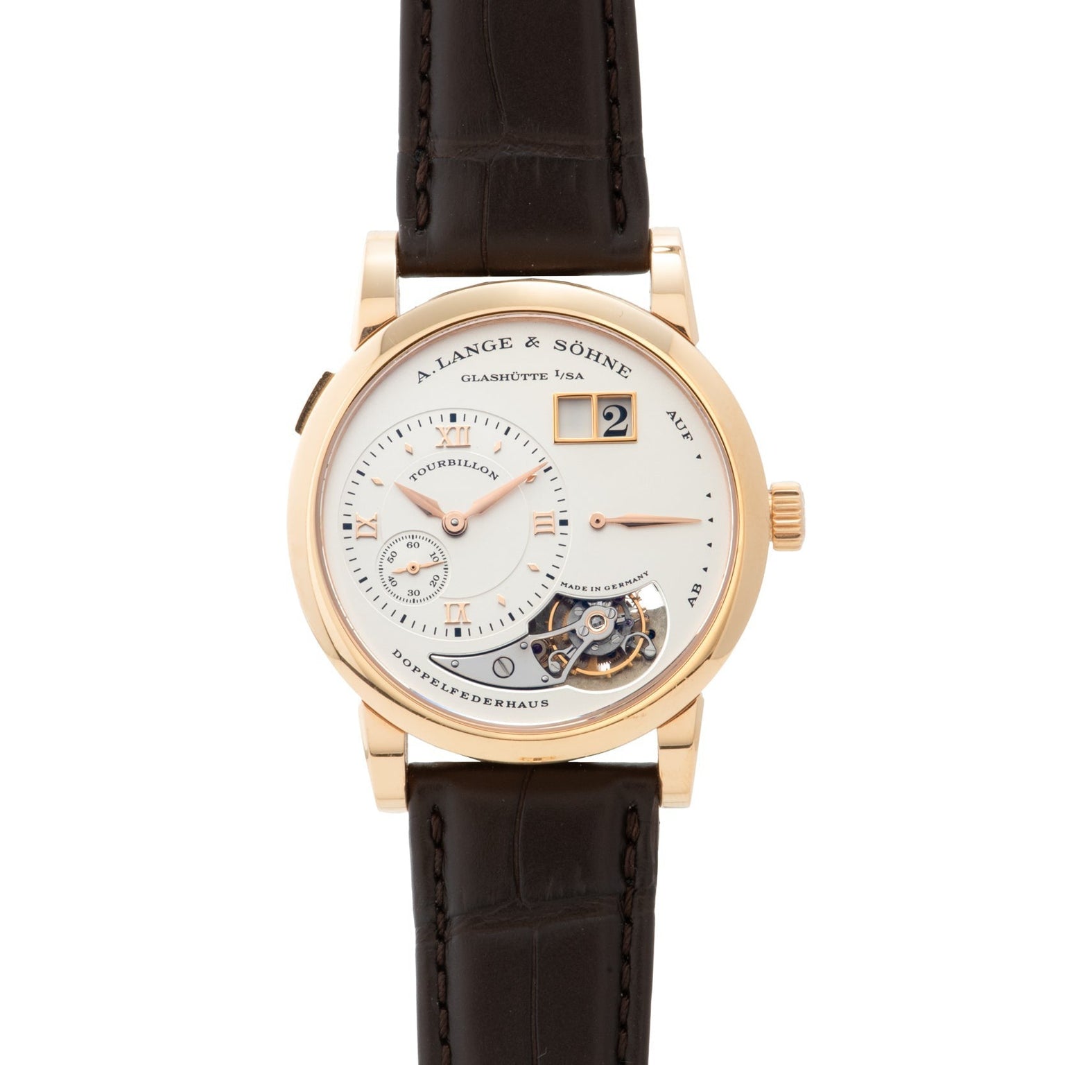 The Lange & Sohne Lange 1 Tourbillon is a luxury wristwatch featuring a brown leather strap and an exposed tourbillon mechanism.