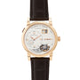 The Lange & Sohne Lange 1 Tourbillon is a luxury wristwatch featuring a brown leather strap and an exposed tourbillon mechanism.