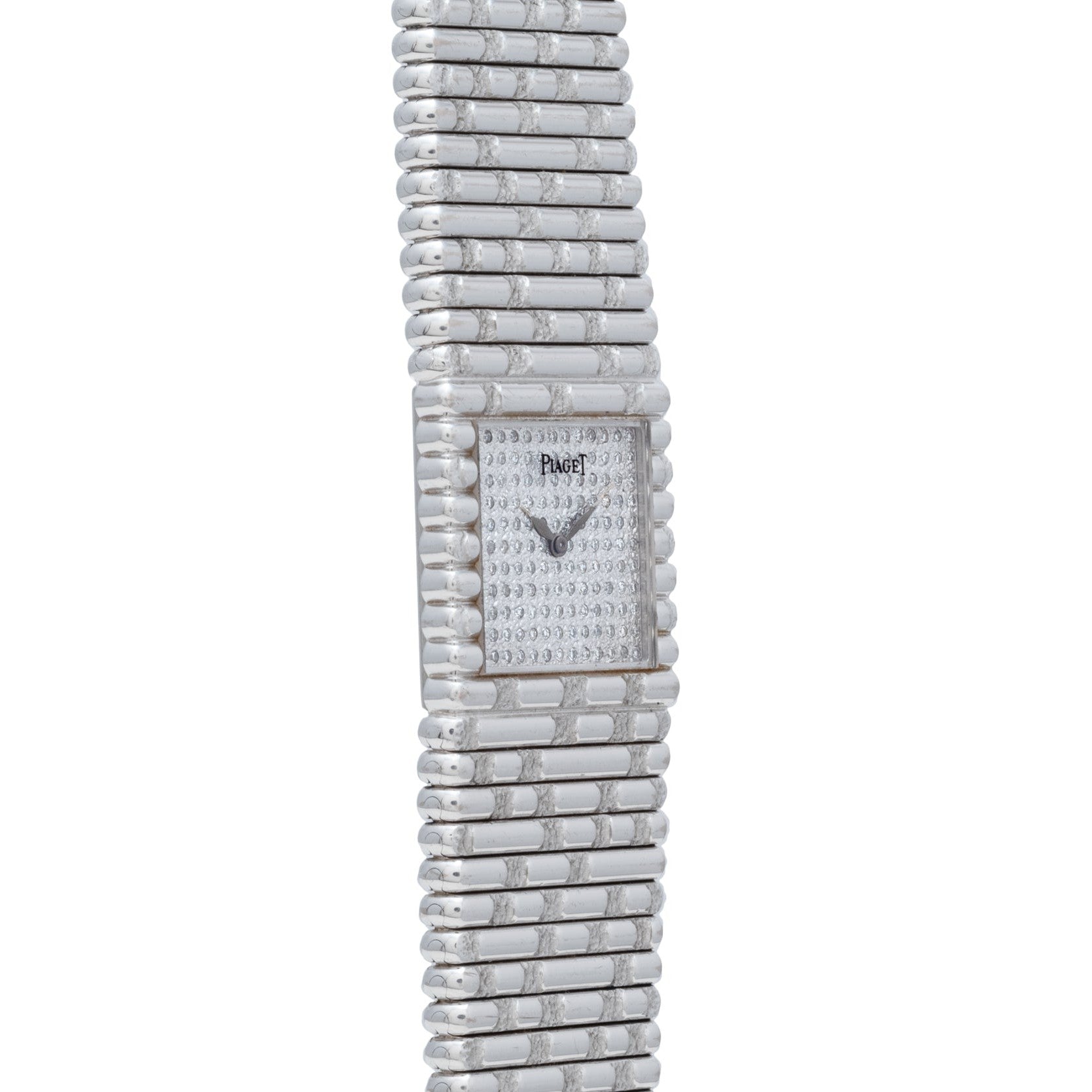 The Piaget Emperador Diamond is a silver luxury watch featuring a rectangular diamond-studded face and a textured metal band.