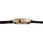 Side view of the Cartier Vendome gold wristwatch featuring a dark round crown and a thin black leather strap.