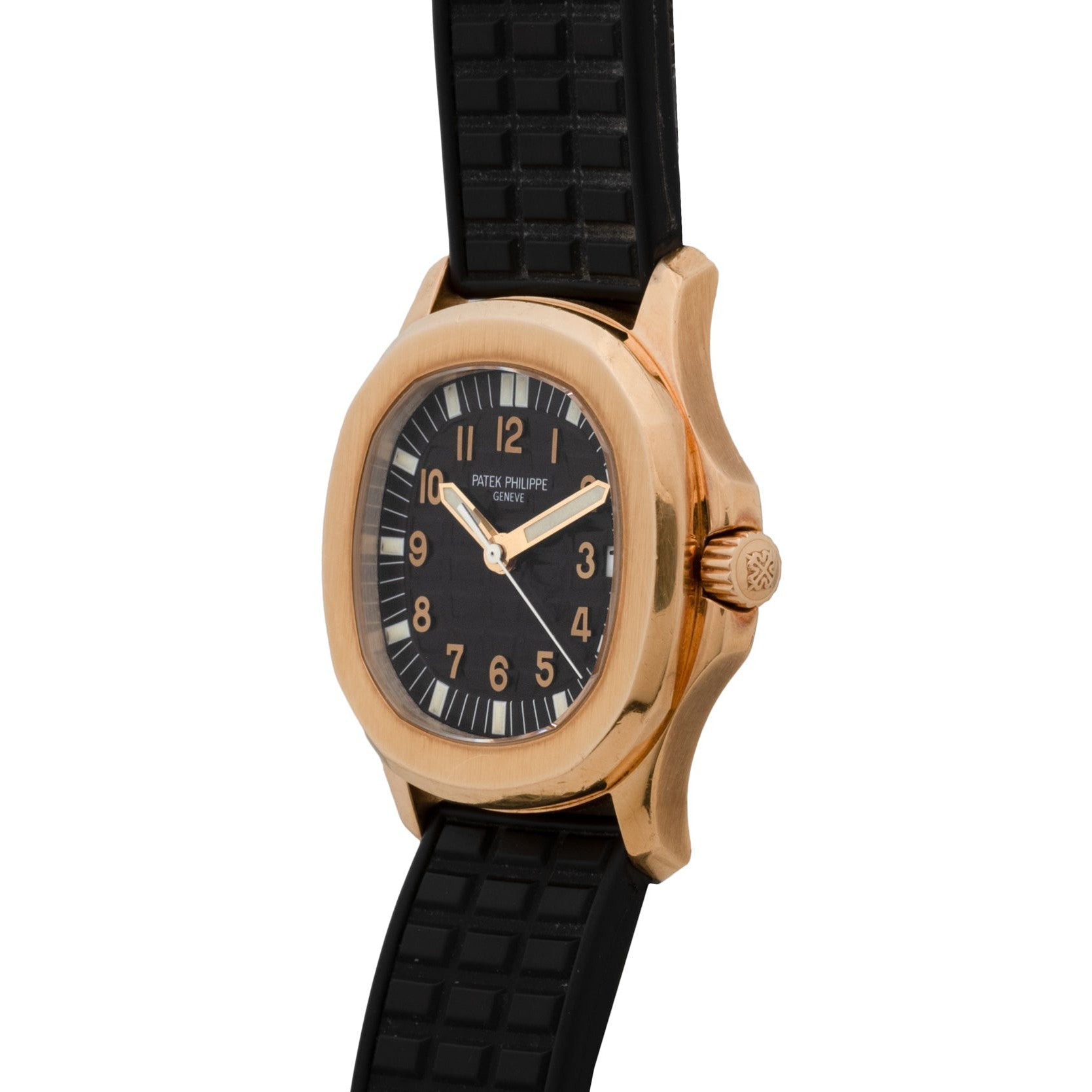 The Patek Philippe Aquanaut is a gold wristwatch with a black face and textured black rubber strap, shown displaying the time 8:02.