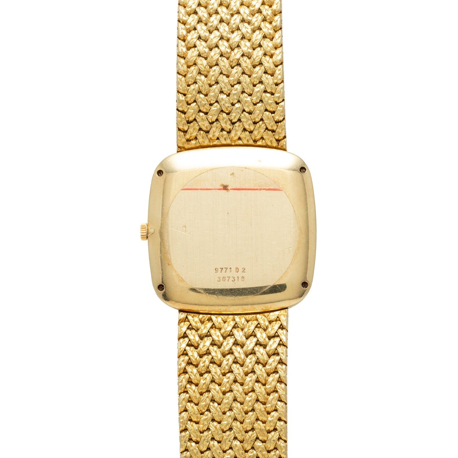 The Piaget Pave Lapis Lazuli Dress Watch is shown from the back, featuring a textured gold band and visible serial numbers on the case.