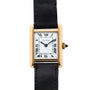 A Cartier Tank Piccolo watch featuring a gold rectangular case, Roman numeral dial, and black leather strap.