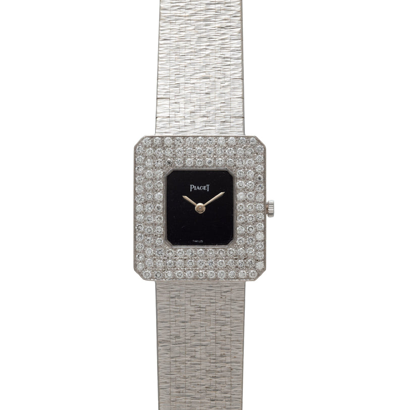 The Piaget Onyx Diamond Dress Watch features a diamond-encrusted square bezel and a textured silver band.