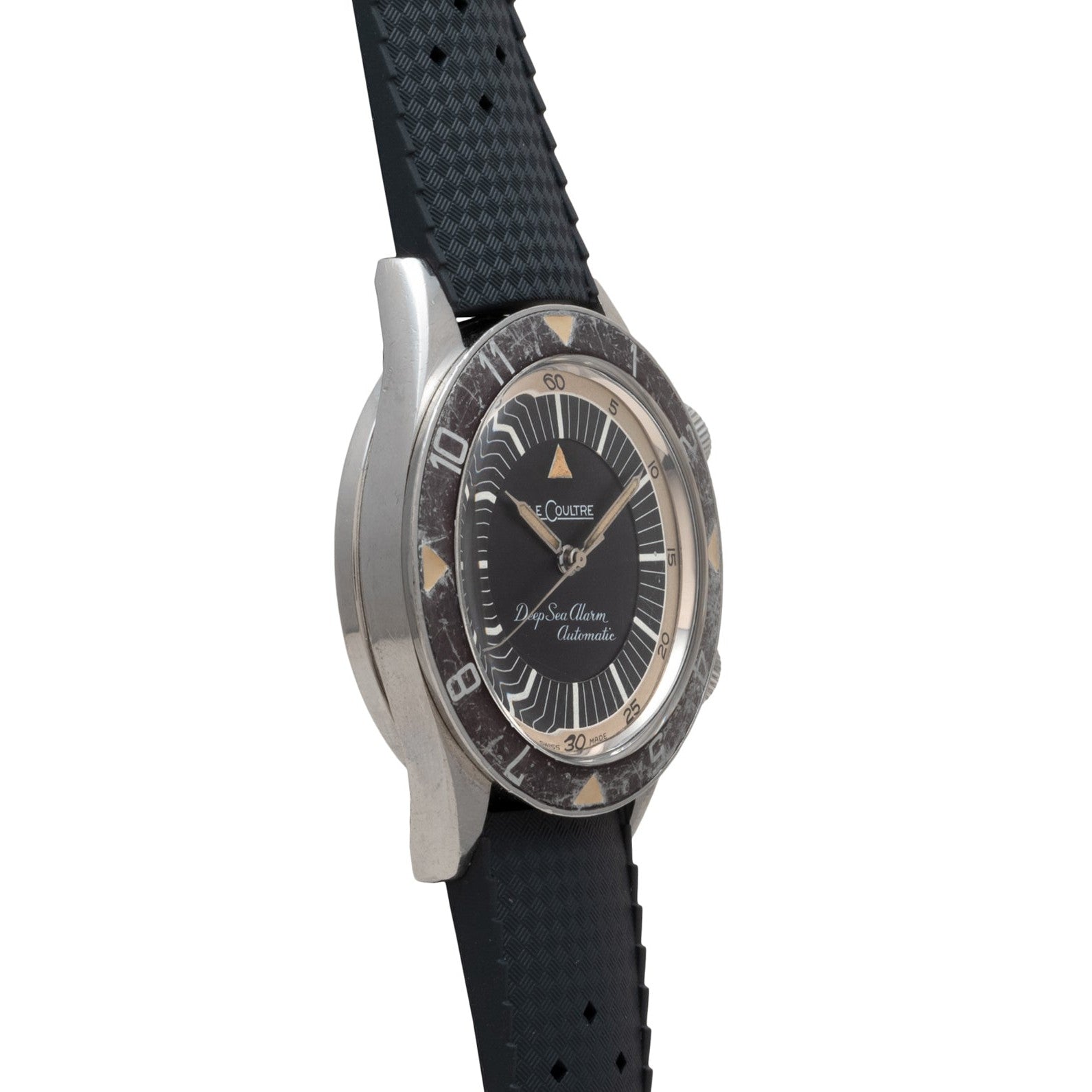 A Jaeger-LeCoultre Deep Sea Alarm U.S. Edition dive watch with a black strap and worn rotating bezel, shown in side profile.