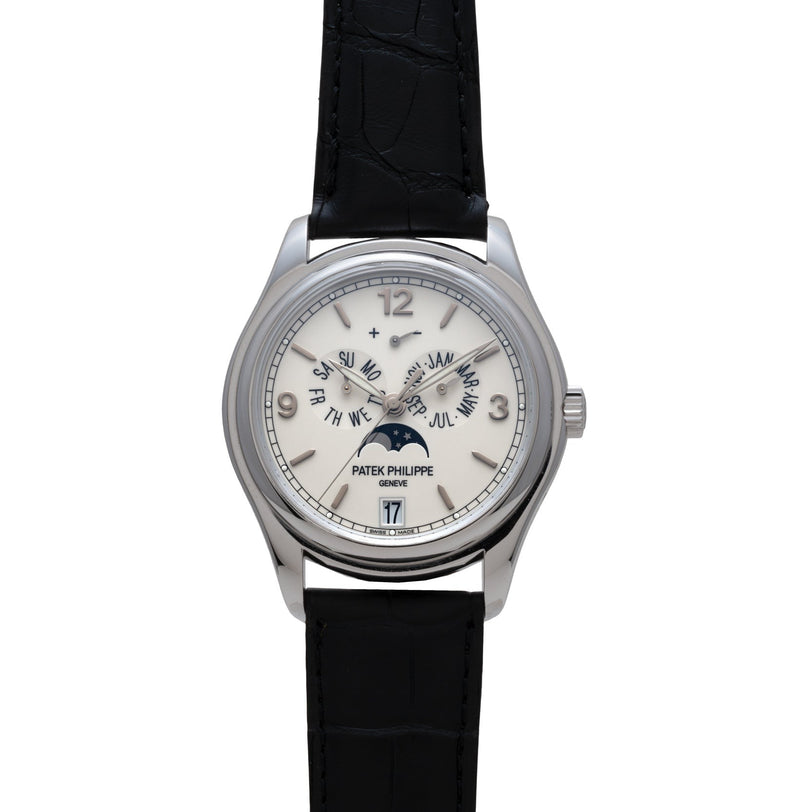 The Patek Philippe Annual Calendar Moonphase features a white dial with moon phase and calendar displays, complemented by a black leather strap.