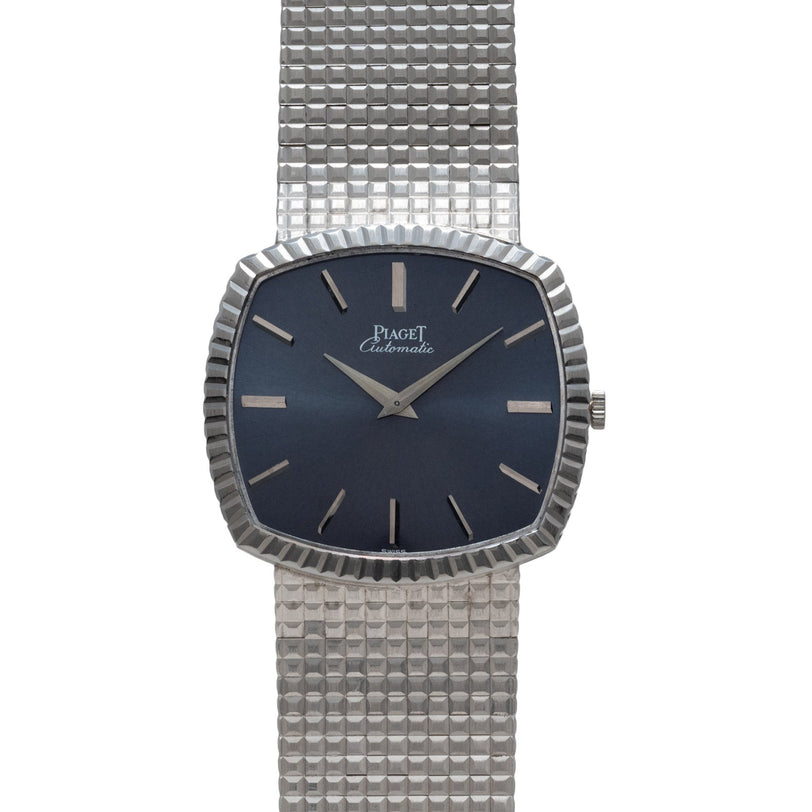 A Piaget Sqound White Gold Dress Watch featuring a textured band and a dark blue square dial.