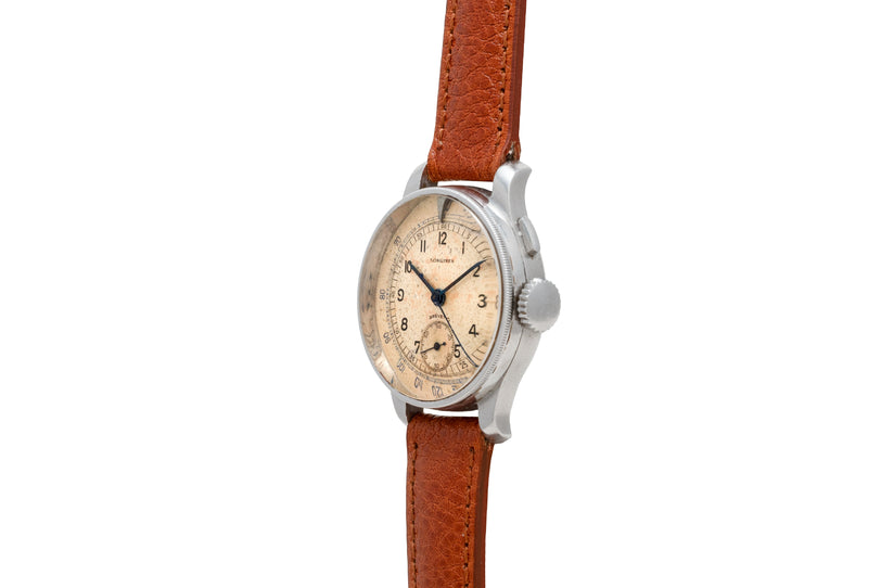 Vintage Longines chronograph watch with cream dial, Arabic numerals, and brown leather strap.