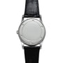 The Patek Philippe Retrograde Perpetual Calendar features a silver case, a minimalist white dial, and a black leather strap with no visible numbers or hands.