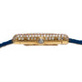 Side view of the Cartier Tank Louis Diamonds gold watch case with diamond accents and a blue leather strap.