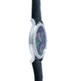 Side view of the Patek Philippe Calatrava Cloisonné Iris & Night Fireflies wristwatch, featuring a black leather strap and a floral design on the watch face.