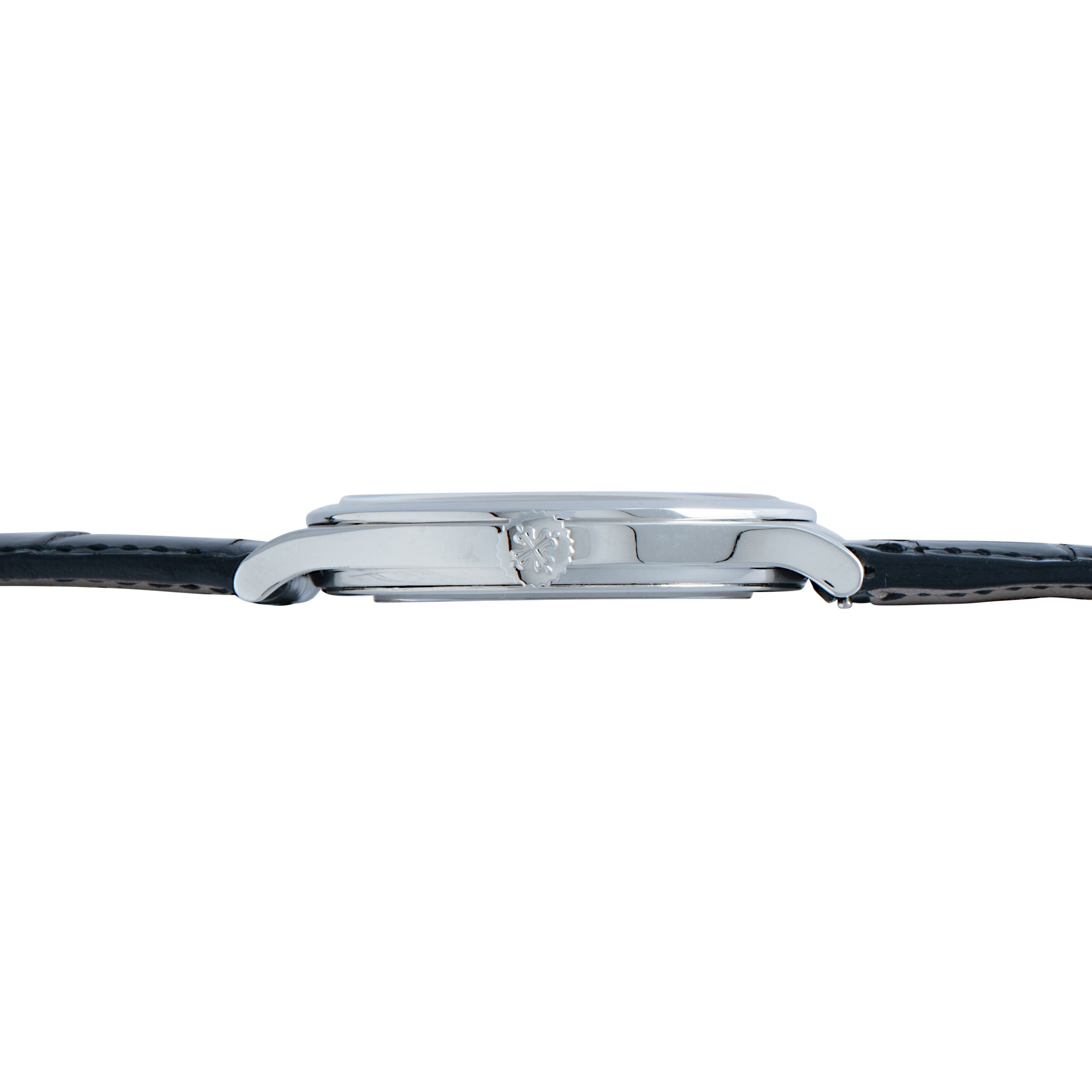 Side view of the Patek Philippe Calatrava Cloisonné Iris & Night Fireflies silver wristwatch with a black leather strap and a textured crown.